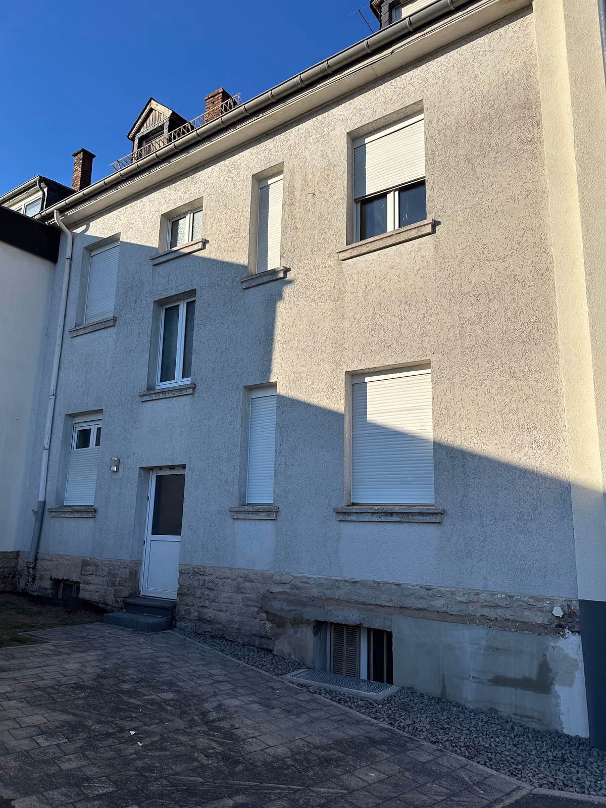 Clean, bright multi-family house facade after facade cleaning